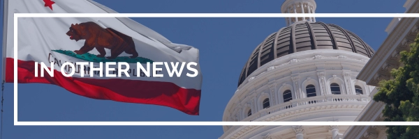 Capitol building in Sacramento with California flag in the foreground
