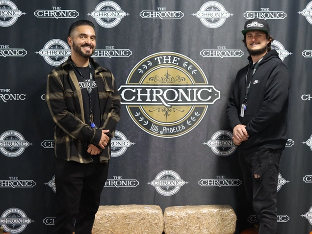 Orlando Padilla, left, poses in from a promotional banner with Travis Miller, managing partner of The Chronic, a social equity cannabis retail store.