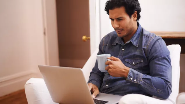 MHO-in-spanish-latino-man-on-computer.jpg Man at table