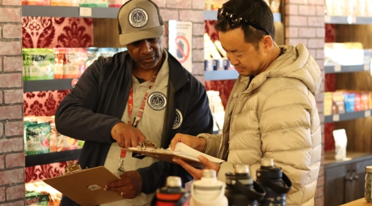 Two DCR Staff reviewing a document in store
