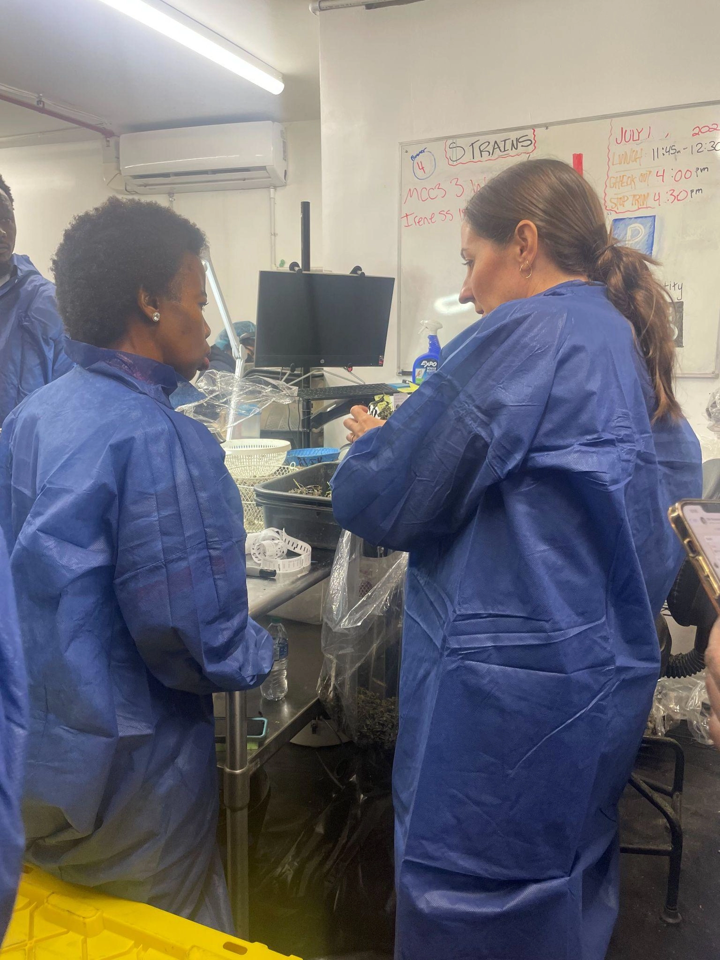 Interim Executive Director Michelle Garakian (right) tours a Los Angeles-based manufacturing facility with members of the South African delegation.