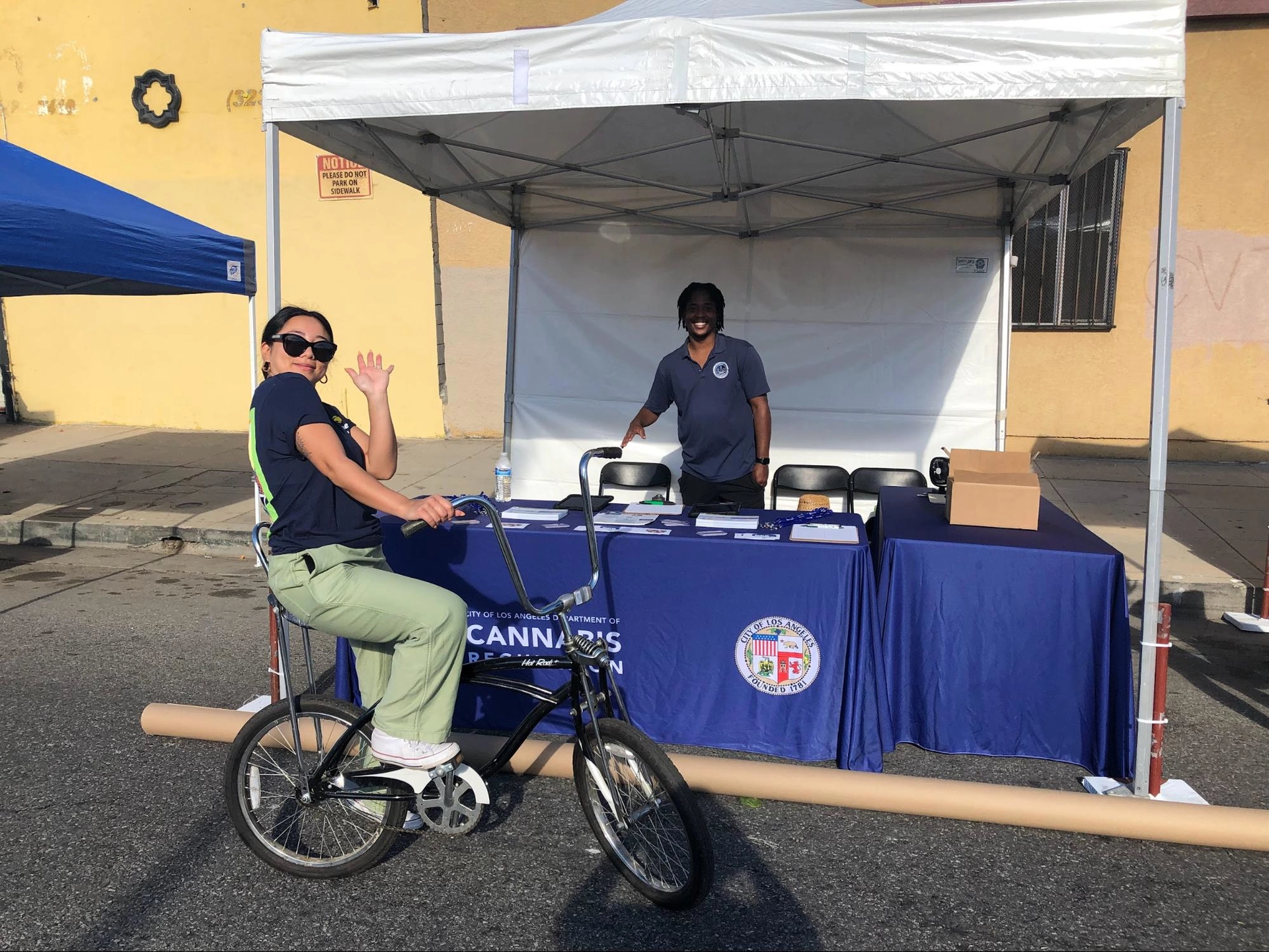 Woman on a bike in front of a tent