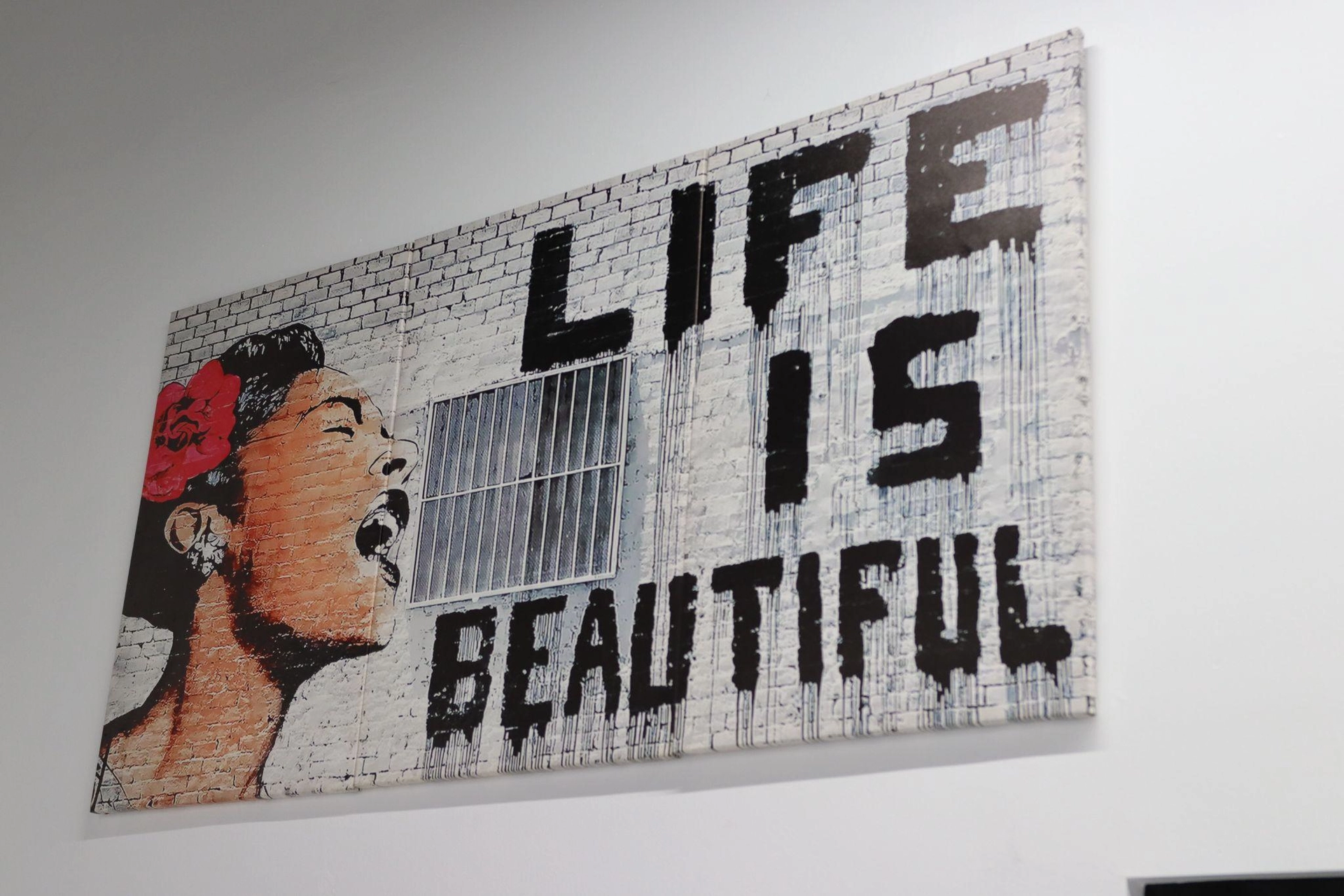 image of artwork that has a profile of woman with a flower in her hair and that reads LIFE IS BEAUTIFUL
